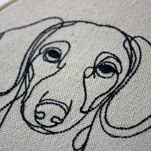 Embroidery of a dog's face on fabric
